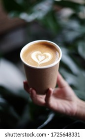 Hot Coffee With Latte Art Hold By Hand