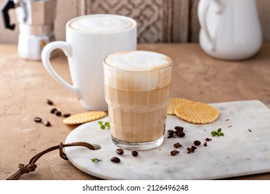Hot coffee latte and cappuchino in a glass and white mug