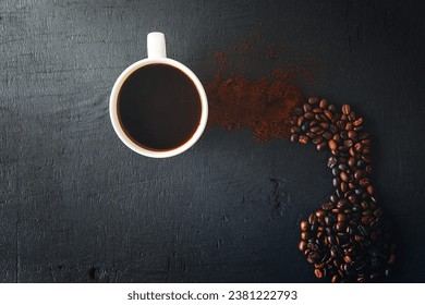 Hot coffee with coffee powder and coffee beans on a black background
