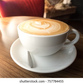 hot coffee in white cup on wood desk