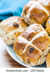 Hot Cross Buns, Spiced Sweet Bread Coated In Honey Piled On A Blue Plate