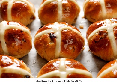 Hot cross buns,freshly baked hot cross buns on white parchment paper, close-up. Traditional easter food
