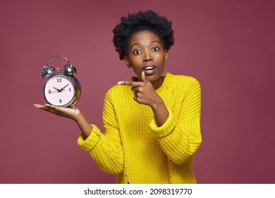 Hot Deadline. Stressed Worried Young African American Girl Holding Alarm Clock Pointing On Remaining Time. Hurry Up