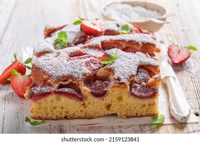 Hot and delicious strawberry cake with fresh fruits and sugar. Homemade sponge cake.