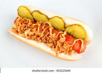 Hot dog with cucumber and onions on a plate
