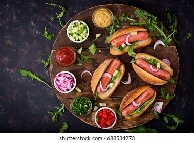 Hot Dog With Cucumber, Tomato And Red Onion On Wooden Background. Top View. Flat Lay