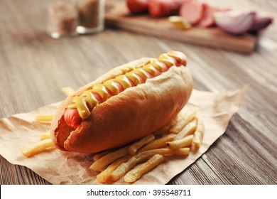 Hot Dog With Fried Potatoes On Craft Paper