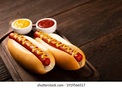 Hot dog with ketchup and yellow mustard. - Shutterstock ID 1919566517