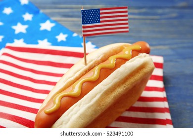 Hot Dog With Mustard And Small USA Flag On Napkin