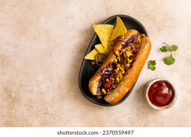 Hot dog with sweet corn, jalapenos, red cabbage, and nachos. Food background with copy space. Top view. - Powered by Shutterstock