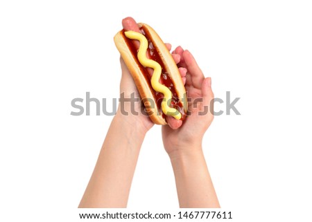 Hot dog in woman hand isolated on white background. Copy space.