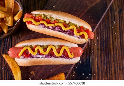  Hot Dog With Yellow Mustard, Onion, Pickles and French Fries - Shutterstock ID 557405038