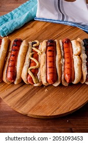 Hot Dogs. Bratwurst, A Pork Sausage In A Hot Dog Bun Topped With Classic Condiments Mustard, Ketchup And Sauerkraut. Classic Traditional American Baseball Game Ballpark Concession Stand Item.