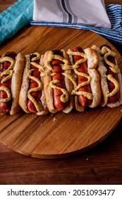 Hot Dogs. Bratwurst, A Pork Sausage In A Hot Dog Bun Topped With Classic Condiments Mustard, Ketchup And Sauerkraut. Classic Traditional American Baseball Game Ballpark Concession Stand Item.