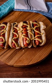 Hot Dogs. Bratwurst, A Pork Sausage In A Hot Dog Bun Topped With Classic Condiments Mustard, Ketchup And Sauerkraut. Classic Traditional American Baseball Game Ballpark Concession Stand Item.