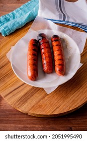 Hot Dogs. Bratwurst, A Pork Sausage In A Hot Dog Bun Topped With Classic Condiments Mustard, Ketchup And Sauerkraut. Classic Traditional American Baseball Game Ballpark Concession Stand Item.