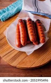 Hot Dogs. Bratwurst, A Pork Sausage In A Hot Dog Bun Topped With Classic Condiments Mustard, Ketchup And Sauerkraut. Classic Traditional American Baseball Game Ballpark Concession Stand Item.