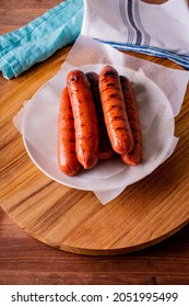 Hot Dogs. Bratwurst, A Pork Sausage In A Hot Dog Bun Topped With Classic Condiments Mustard, Ketchup And Sauerkraut. Classic Traditional American Baseball Game Ballpark Concession Stand Item.