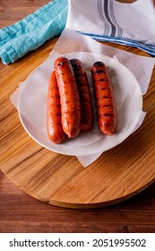 Hot Dogs. Bratwurst, A Pork Sausage In A Hot Dog Bun Topped With Classic Condiments Mustard, Ketchup And Sauerkraut. Classic Traditional American Baseball Game Ballpark Concession Stand Item.