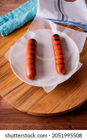 Hot Dogs. Bratwurst, A Pork Sausage In A Hot Dog Bun Topped With Classic Condiments Mustard, Ketchup And Sauerkraut. Classic Traditional American Baseball Game Ballpark Concession Stand Item.