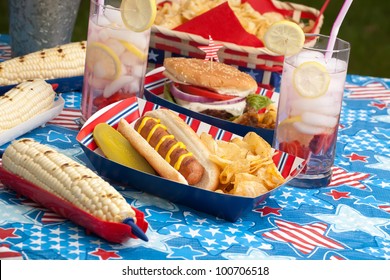 Hot Dogs, Corn And Burgers On 4th Of July Picnic In Patriotic Theme