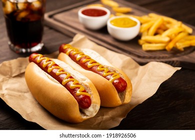 Hot dogs with ketchup, yellow mustard, french fries and soda. Image with selective focus. - Shutterstock ID 1918926506