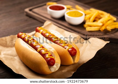 Hot dogs with ketchup, yellow mustard and fries. Image with selective focus Foto stock © 