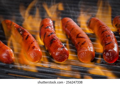 Hot Dogs On A Flaming Hot Barbecue Grill