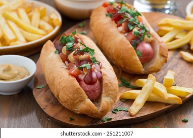 hot dogs with tomato salsa and onions on wooden board, horizontal - Powered by Shutterstock