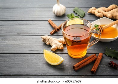 Hot drink with honey, lemon and ginger for cough remedy on wooden table - Powered by Shutterstock