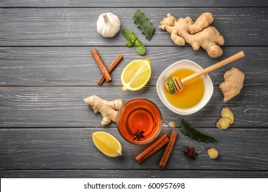 Hot drink with honey, lemon and ginger for cough remedy on wooden table - Shutterstock ID 600957698