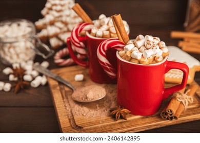 Hot drink with marshmallows and candy cane in  cup on a texture table.Cozy seasonal holidays.Hot cocoa with gingerbread Christmas cookies.Hot chocolate with marshmallow and spices.Copy space. - Powered by Shutterstock