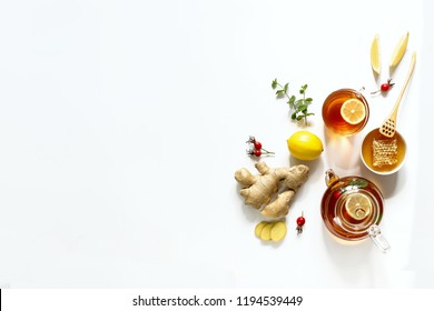 Hot drink, tea with ginger, lemon, honey. White background, top view Top view - Powered by Shutterstock