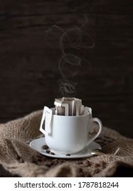Hot Drip Coffee with Steam. Drip Coffee Still Life, Rustic Country Lifestyle. Espresso with Coffee Beans on Dark Background with Copy Space.