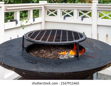 Hot Empty Barbecue BBQ Grill With Flaming Fire And Ember Charcoal On Black Background. Outdoor Summer Family Party Picnic In The Park