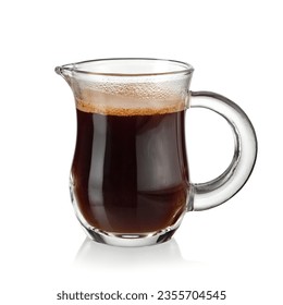 Hot espresso coffee in a small glass jug on white background