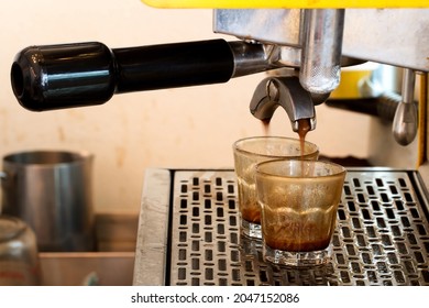 Hot Espresso From A Fresh Coffee Machine.Dirty Mugs And Hot Espresso From A Fresh Coffee Maker. 