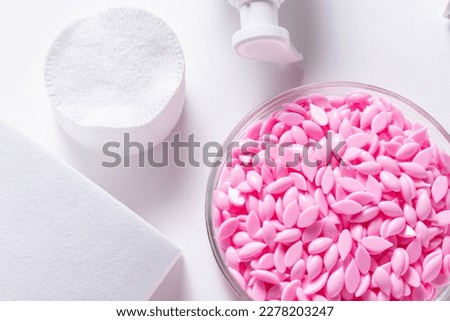 Hot film wax for depilation procedure on white background