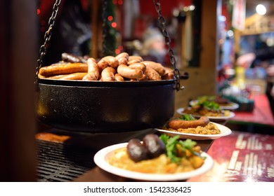 Hot Food On Tallinn Christmas Fair. As Tradions Sausages And Kupaty Is Cooking On An Open Fire.