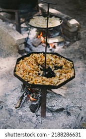 Hot Food. Yummy Potatoes Are Fried In A Large Skillet In Oil Outside. Fried Potatoes In Large Kitchen Pan. Street Food.