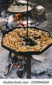 Hot Food. Yummy Potatoes Are Fried In A Large Skillet In Oil Outside. Fried Potatoes In Large Kitchen Pan. Street Food.