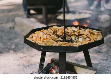 Hot Food. Yummy Potatoes Are Fried In A Large Skillet In Oil Outside. Fried Potatoes In Large Kitchen Pan. Street Food.