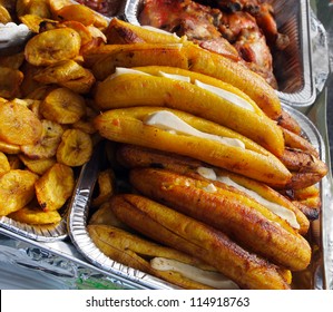 Hot Fried Plantain Slices And Whole Baked Plantains Stuffed With Cheese, In Foil Serving Dishes, Picnic Style.