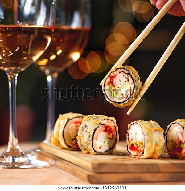 Hot fried sushi roll with salmon and\
wine. Sushi menu. Japanese food. Hot fried sushi\
roll