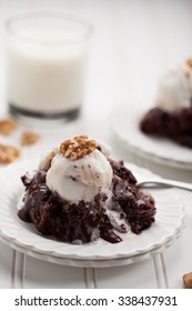 Hot Fudge Chocolate Cake Topped With Caramel Chocolate Vanilla Ice Cream And Walnuts Served With A Cup Of Milk