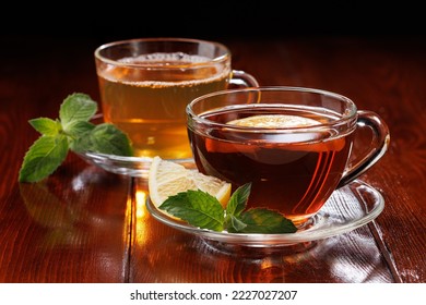 Hot green tea with mint and black tea with lemon and mint in glass cups. Side view. Selective focus. - Powered by Shutterstock