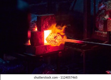 Hot item is inserted into the blacksmith's forge from which the tongues of flame. Concept: blacksmithing, forge - Powered by Shutterstock