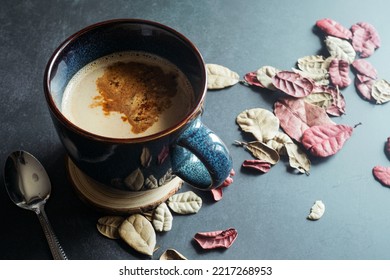 Hot Latte Coffee On The Dark Table With Dry Leaves For Winter Theme