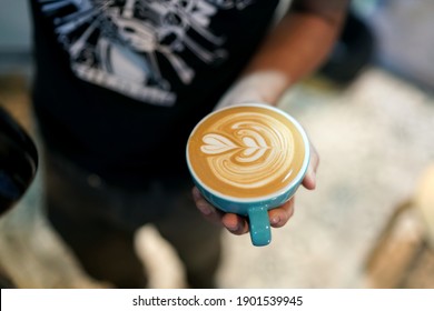 Hot Latte - A Cup Of Coffee With Milk And Beautiful Leaf Pattern Latte Art On Wooden Table And Copy Space, Perfect For Breakfast Time.