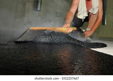 Hot Liquid Mastic Asphalt Is Spread On The Floor By Hand